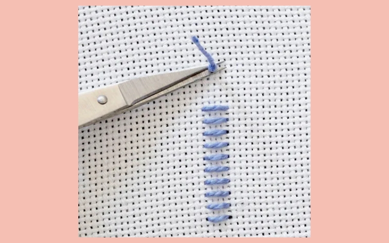 After completing the stitching around the entire perimeter of the patch, securely fasten the thread on the inside of the hat