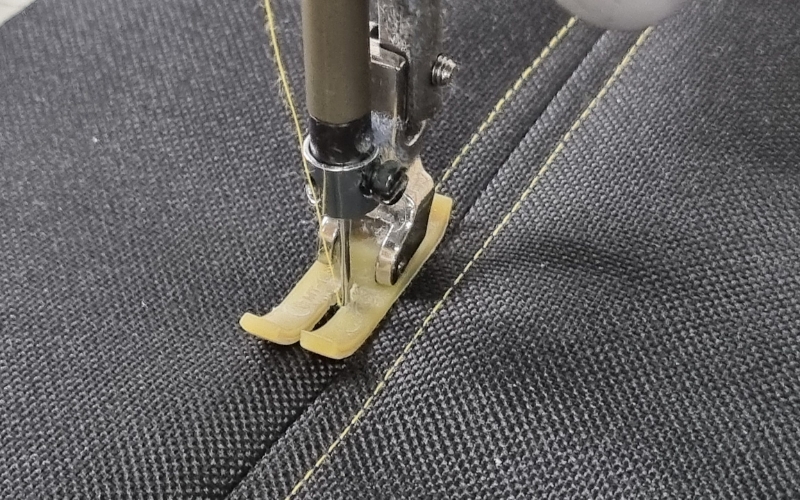 Ensure your sewing machine is equipped with a heavy-duty needle