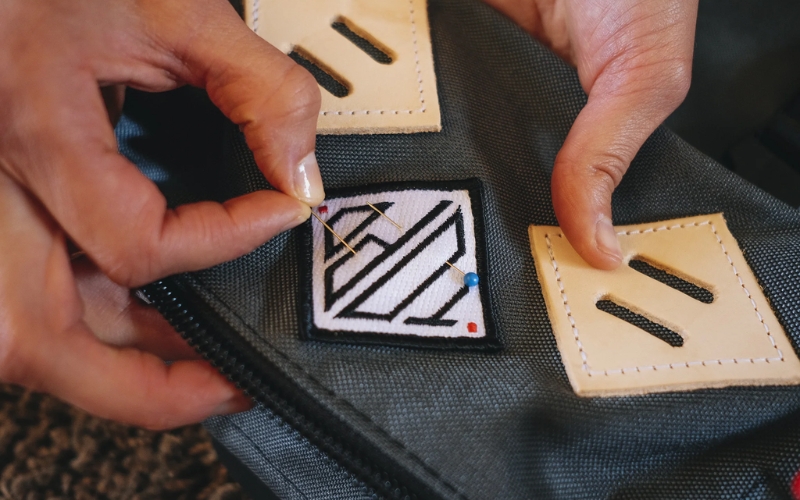 Sewing is a reliable and durable method for attaching patches to a backpack