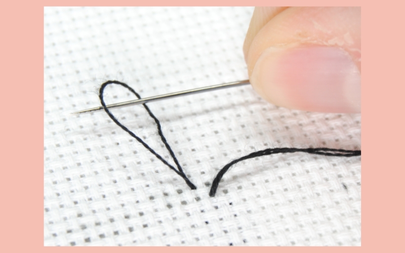 Tie a knot at the end of the thread to secure it