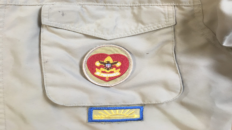 The World Crest Emblem, signifying worldwide Scouting, is centered above the left pocket